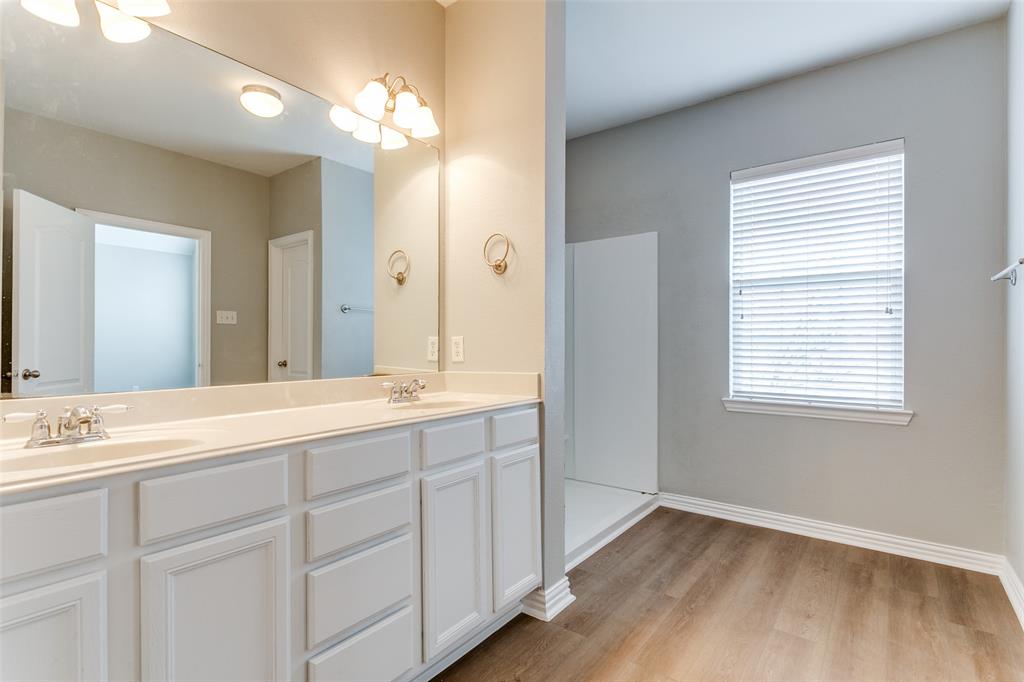 3725 Vienna Street Irving, TX 75038 - Photo 17 of 25 a bathroom with a double vanity sink and a mirror