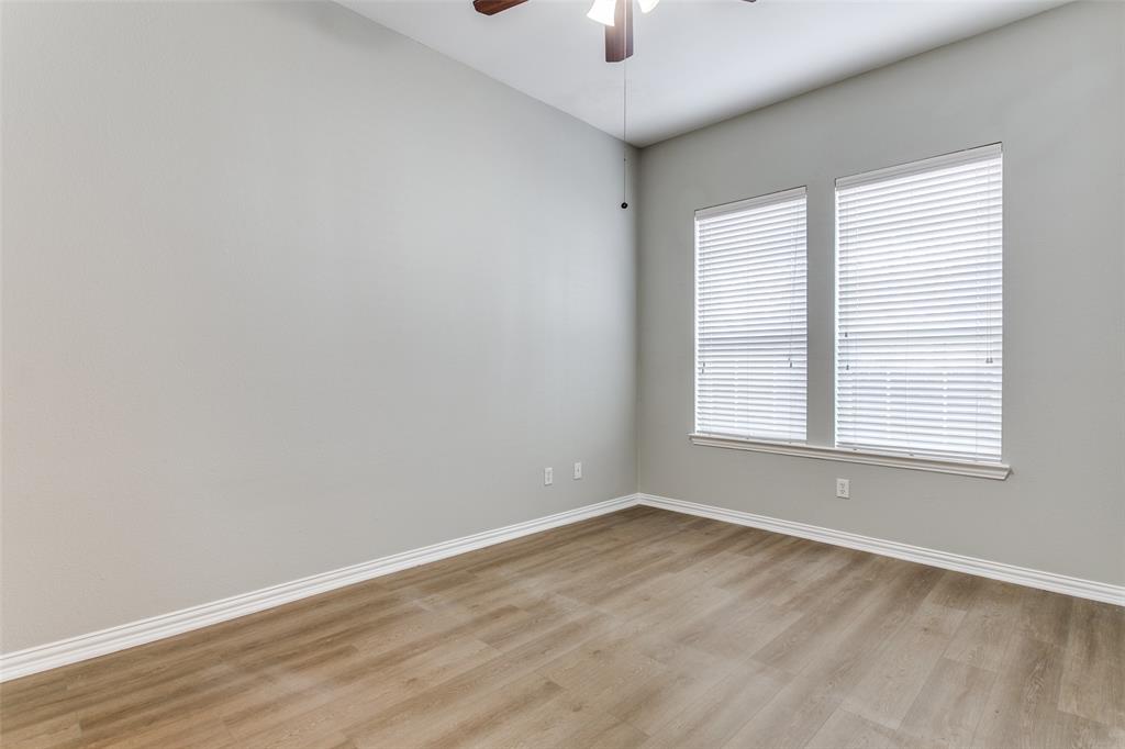 3725 Vienna Street Irving, TX 75038 - Photo 21 of 25 an empty room with a window and wooden floor