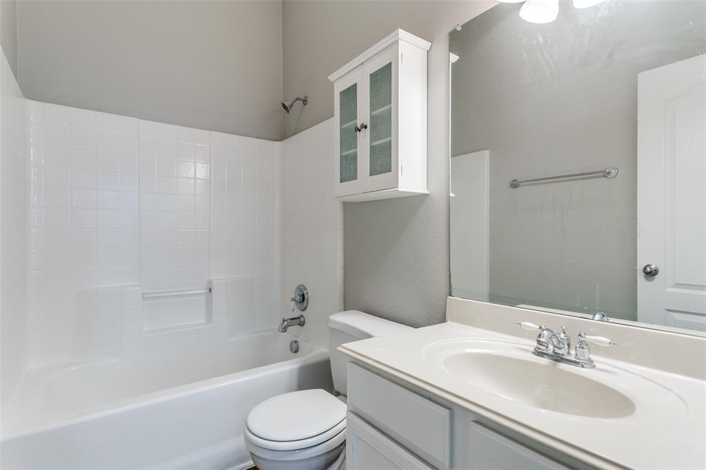 3725 Vienna Street Irving, TX 75038 - Photo 22 of 25 a bathroom with a sink a toilet and shower