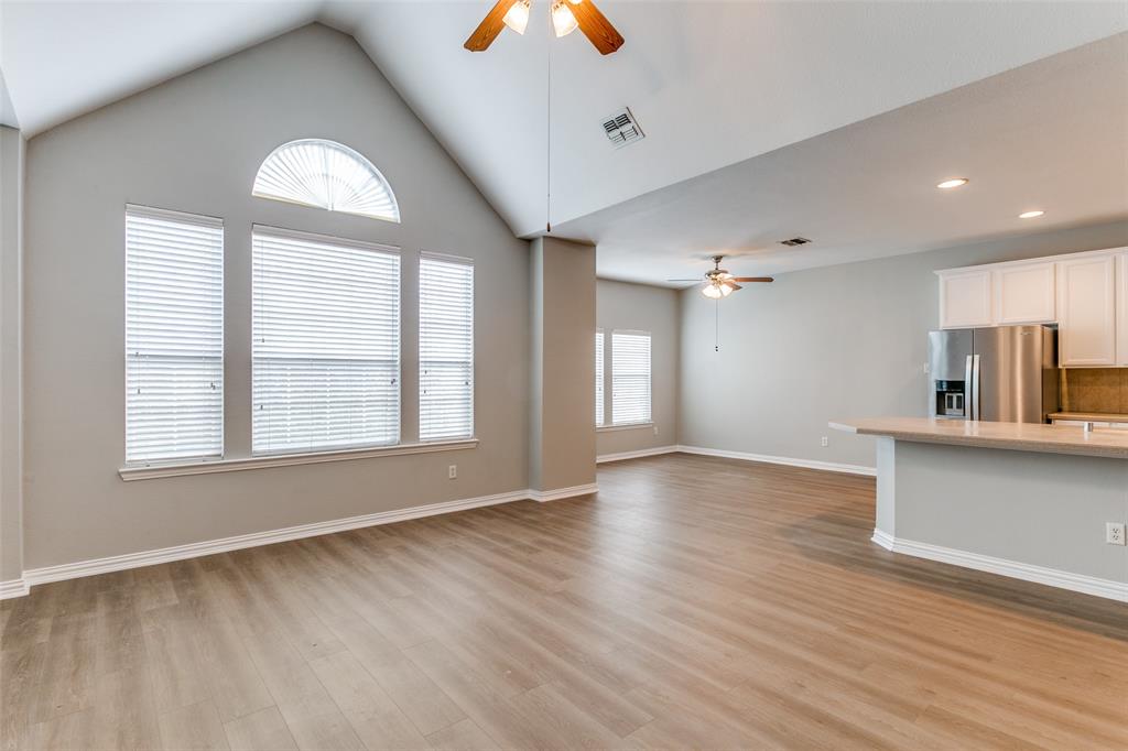 3725 Vienna Street Irving, TX 75038 - Photo 9 of 25 an empty room with wooden floor and windows