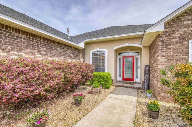 a front view of a house with potted plants