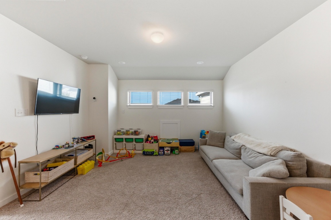 159 Threshing Road, Unit A Buda, TX 78610 - Photo 22 of 33 Playroom with carpet flooring