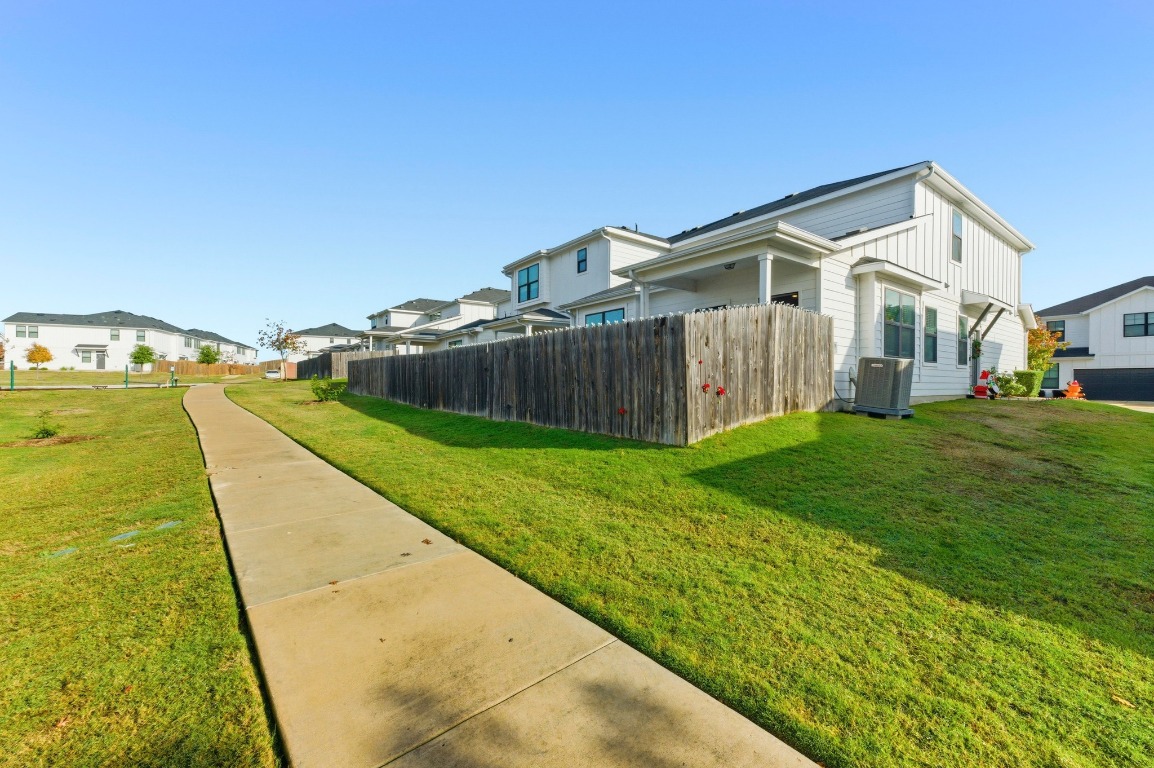 159 Threshing Road, Unit A Buda, TX 78610 - Photo 32 of 33 View of yard featuring a residential view