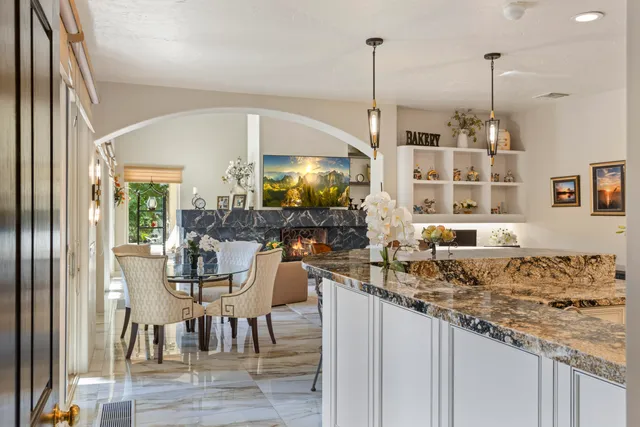 a kitchen with stainless steel appliances kitchen island granite countertop a refrigerator and cabinets