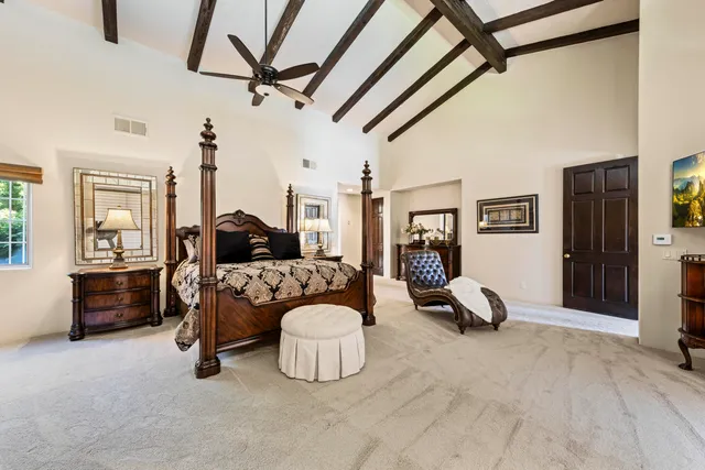 a bedroom with a bed window and a mirror