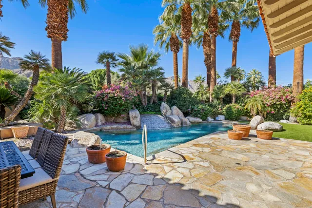 a view of a house with backyard and sitting area