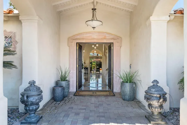 a living room with furniture and potted plant