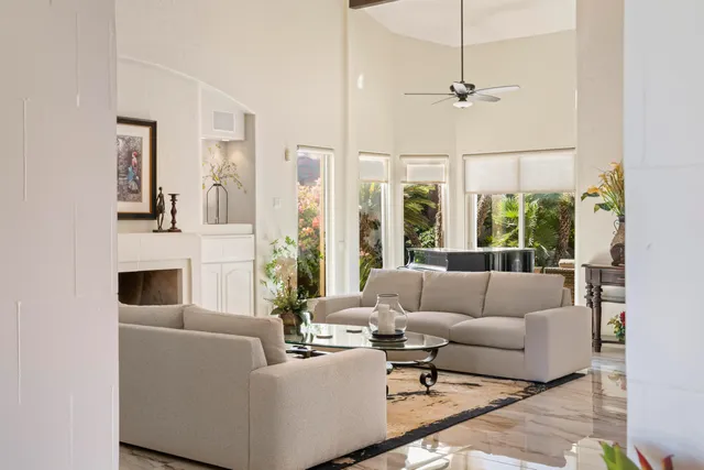 a living room with furniture fireplace and window