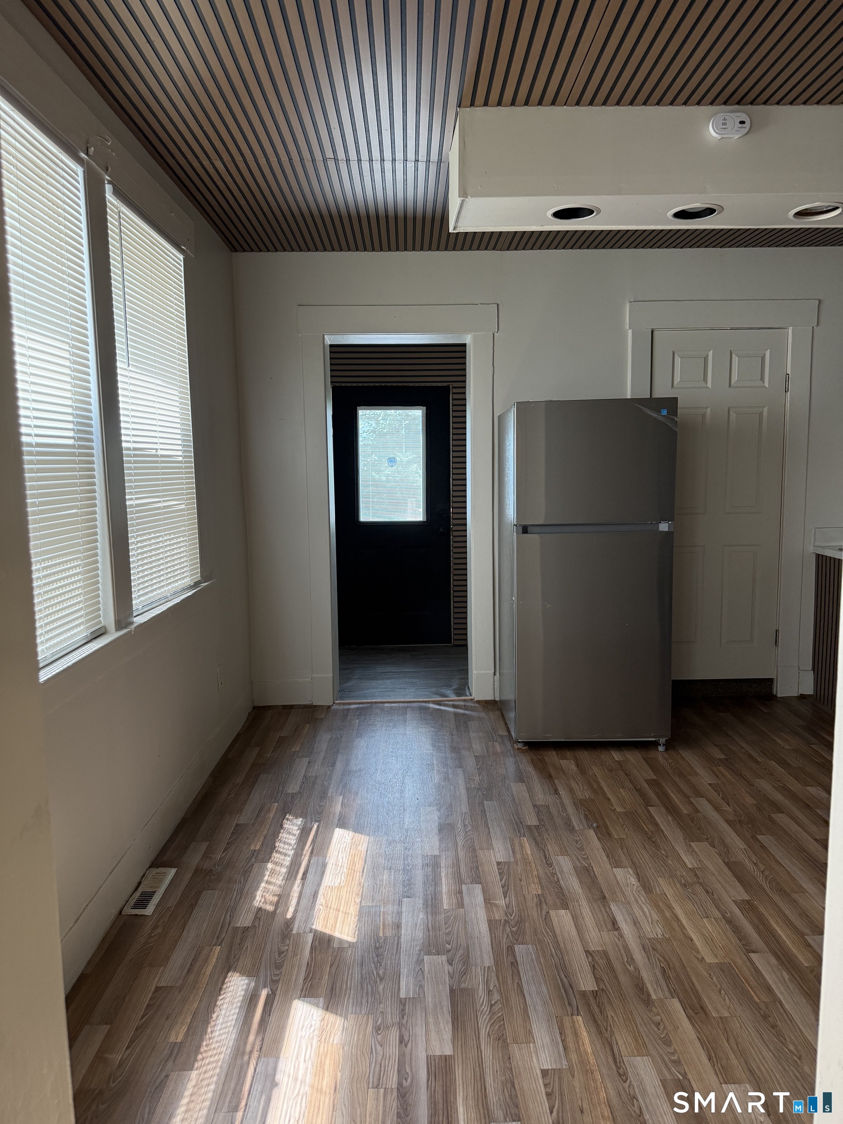 38 Read Street New Haven, CT 06511 - Photo 2 of 10 a view of an empty room with wooden floor and a window