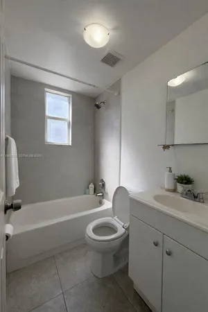 a bathroom with a toilet a sink and bathtub