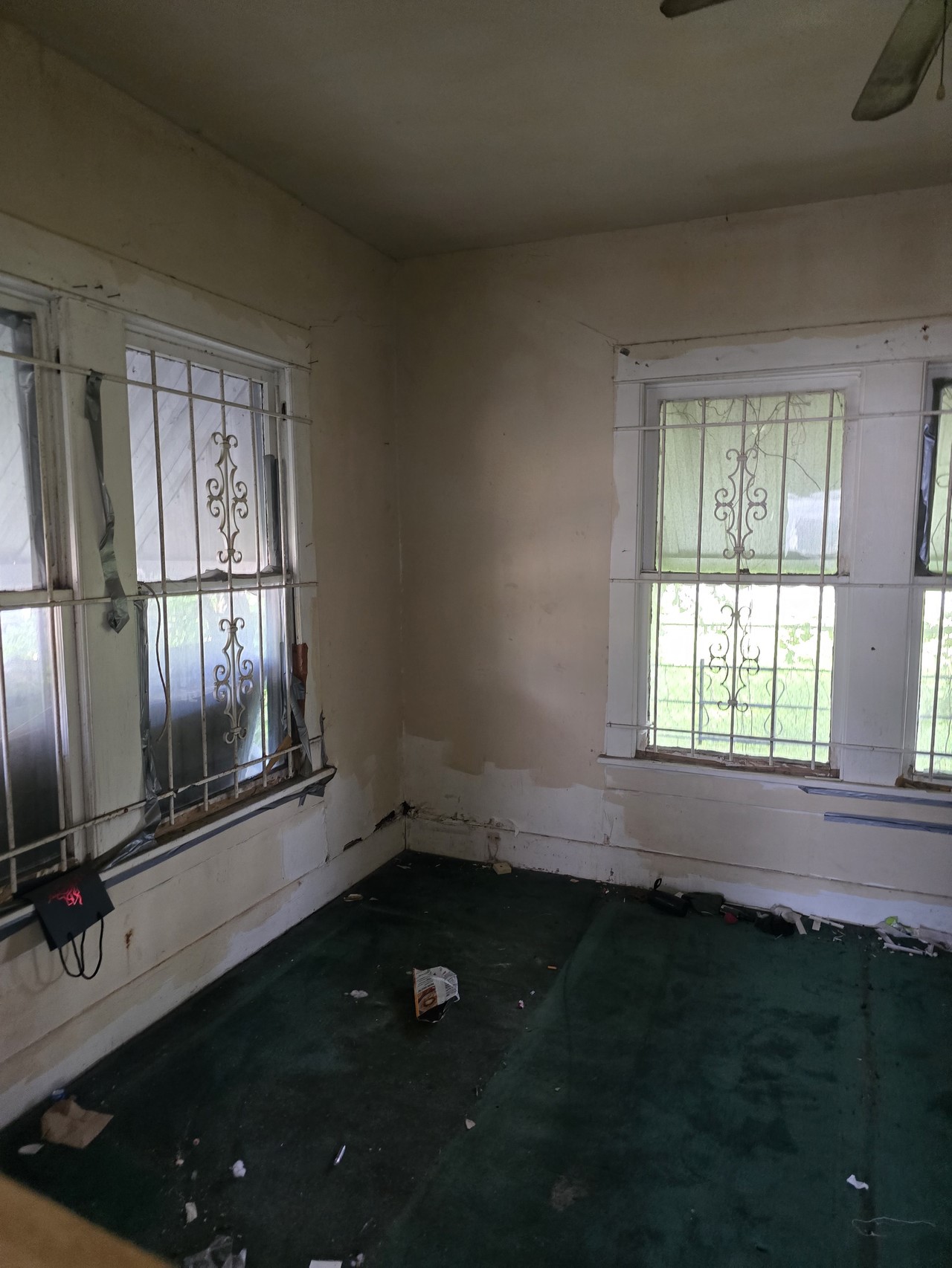 2305 Elysian Street Houston, TX 77026 - Photo 3 of 12 an empty room with wooden floor and windows