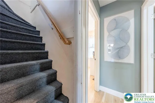 a view of entryway and hall with wooden floor