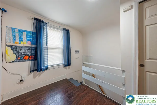 a view of wooden floor and windows in a room