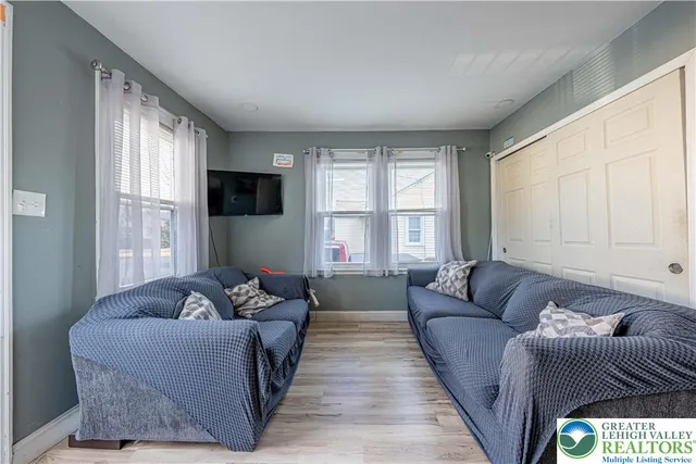 a living room with furniture and a large window