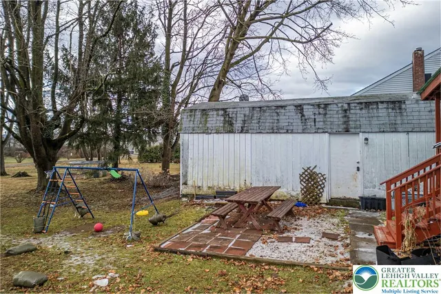 a backyard of a house with outdoor seating