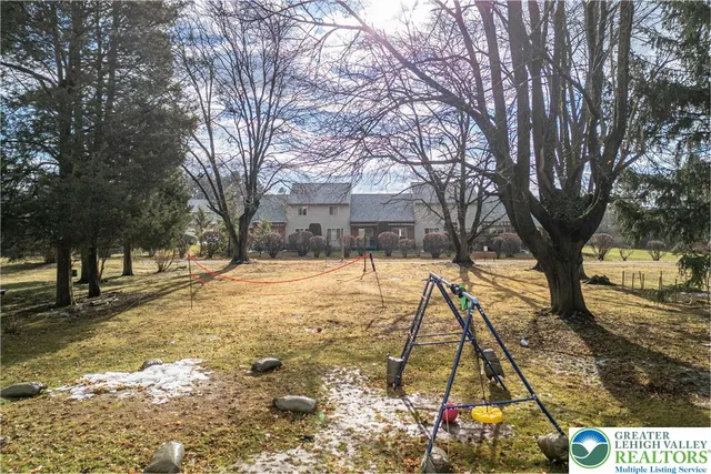 a view of yard covered with snow in front of house