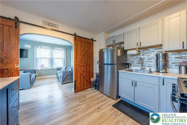 a kitchen with stainless steel appliances granite countertop a refrigerator and a sink
