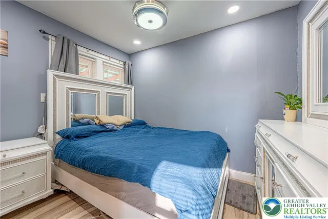 a bedroom with a bed and a window