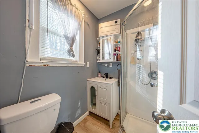 a bathroom with a toilet a sink and a window