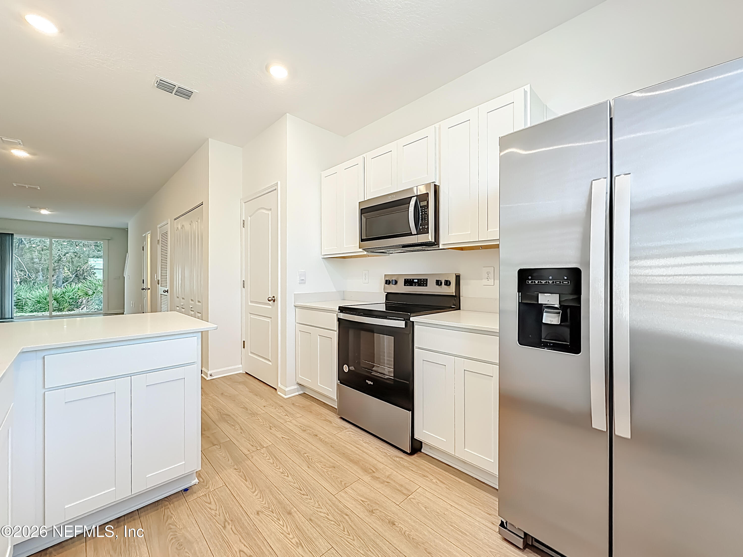 177 Palmetto Rdg Road St. Augustine, FL 32095 - Photo 5 of 19 a kitchen with a refrigerator stove and microwave