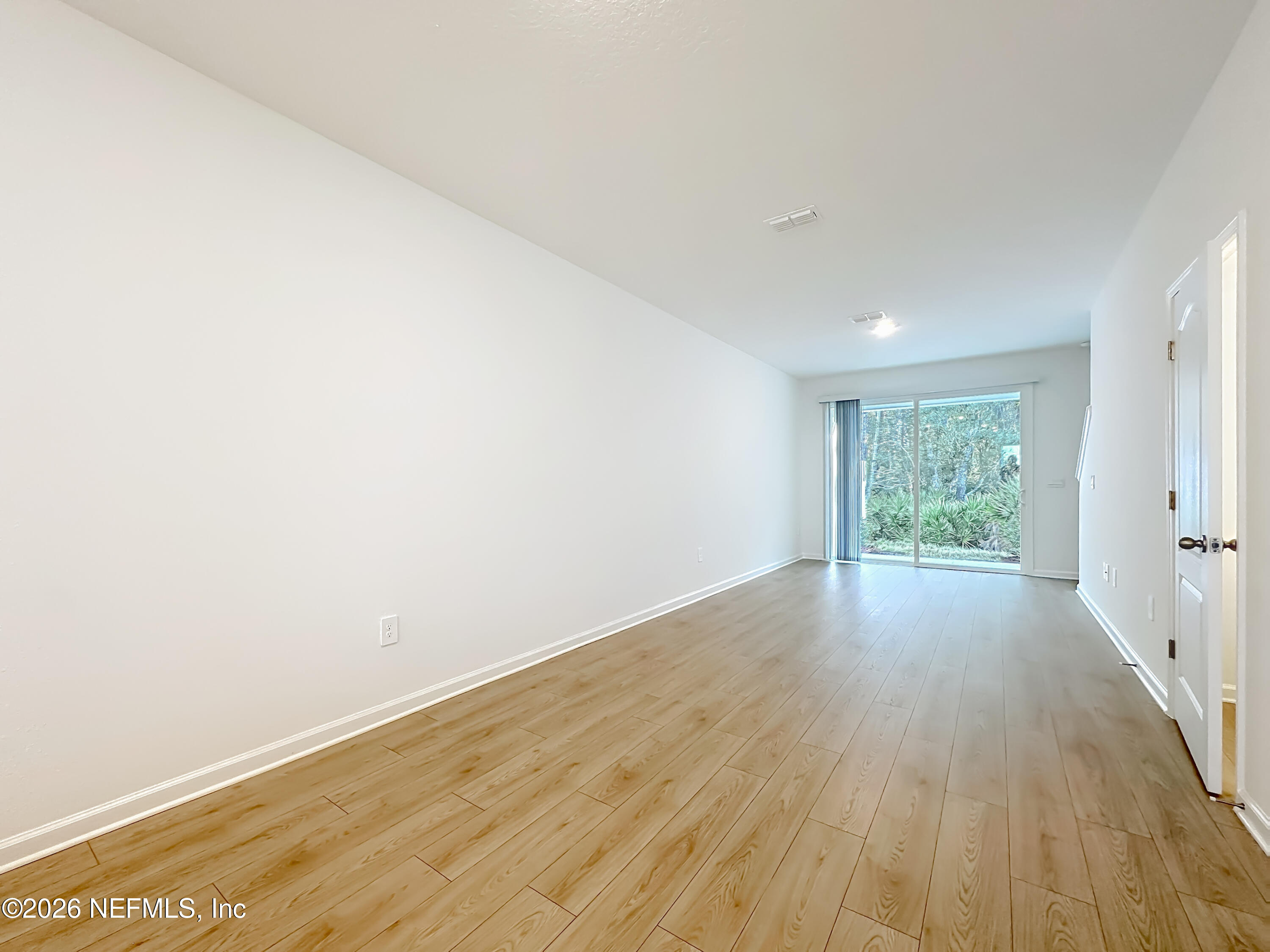 177 Palmetto Rdg Road St. Augustine, FL 32095 - Photo 8 of 19 an empty room with wooden floor and windows