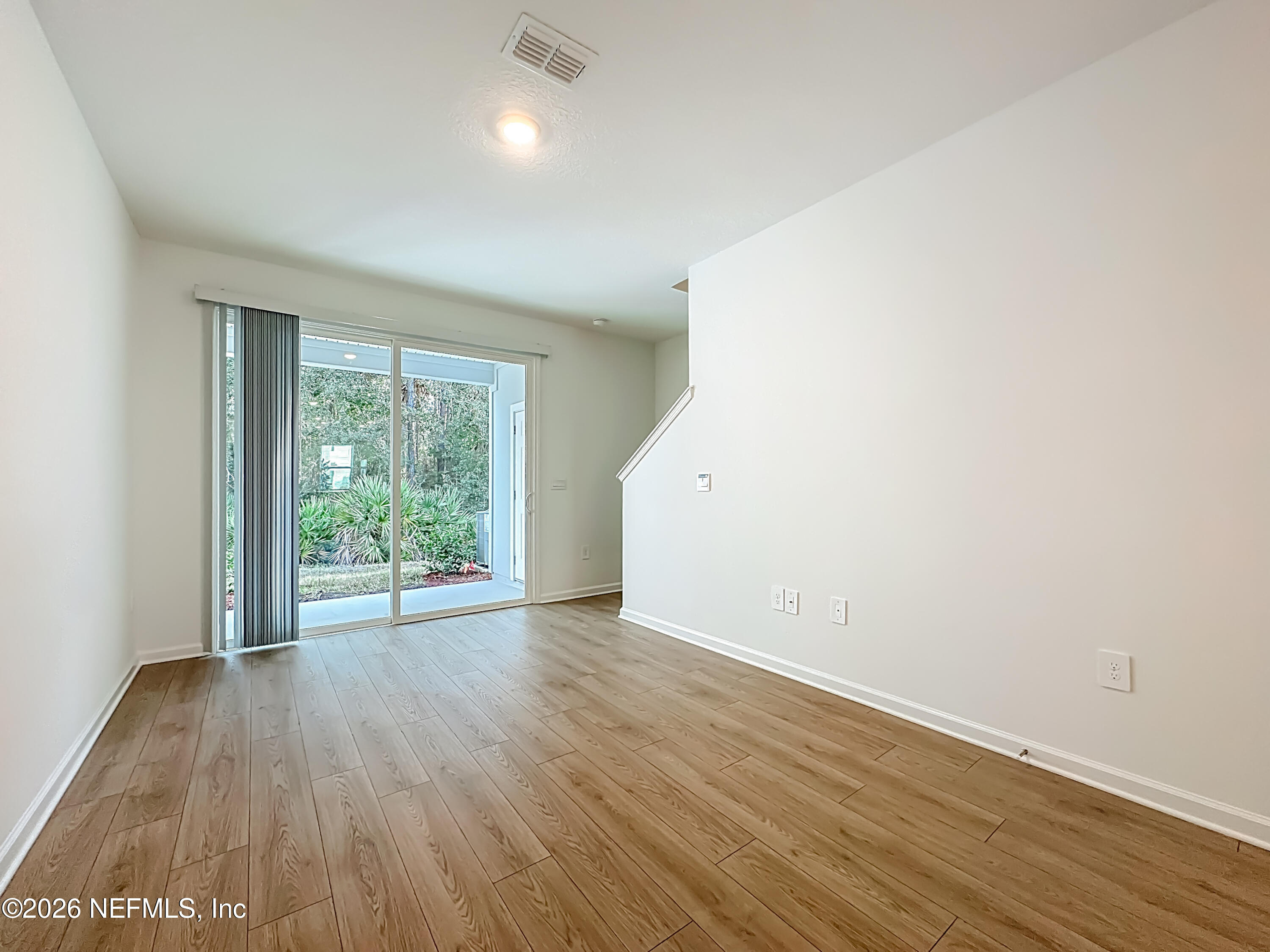 177 Palmetto Rdg Road St. Augustine, FL 32095 - Photo 9 of 19 an empty room with wooden floor and windows
