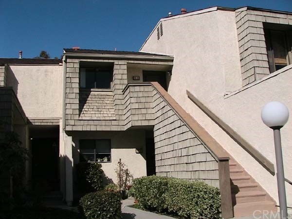 a view of house with wooden fence