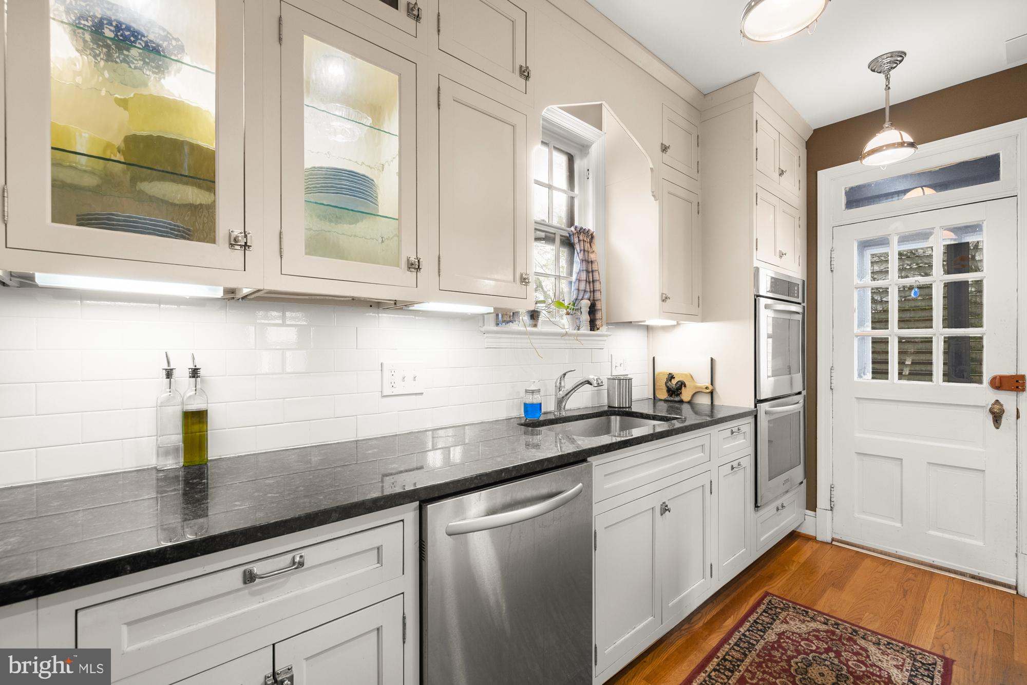 1441 Manchester Lane Northwest Washington, DC 20011 - Photo 14 of 63 a kitchen with stainless steel appliances granite countertop a sink a stove and cabinets