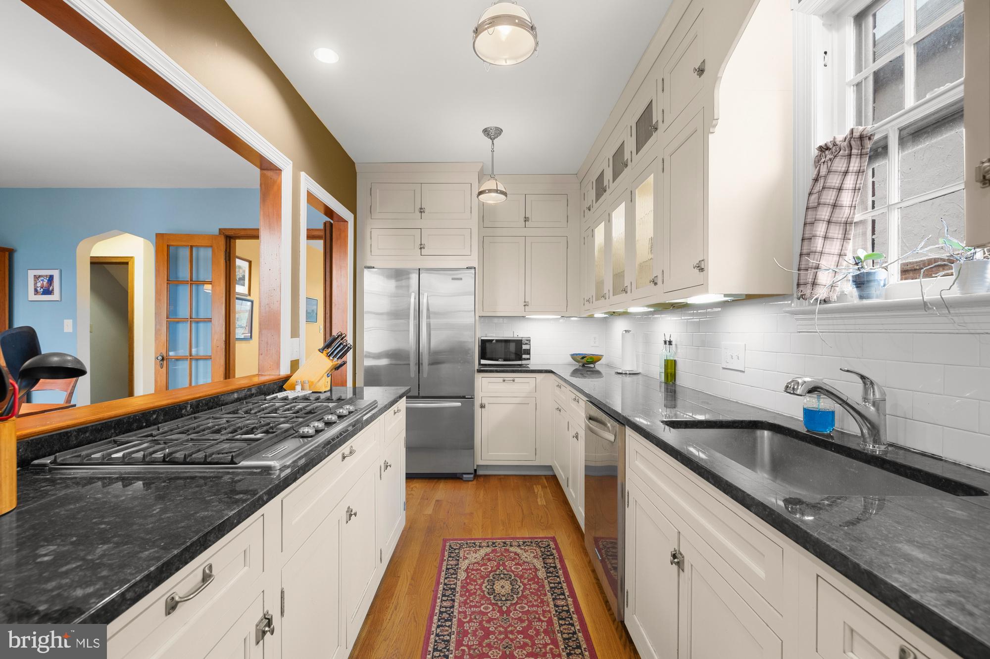 1441 Manchester Lane Northwest Washington, DC 20011 - Photo 16 of 63 a kitchen with granite countertop a sink stove and refrigerator