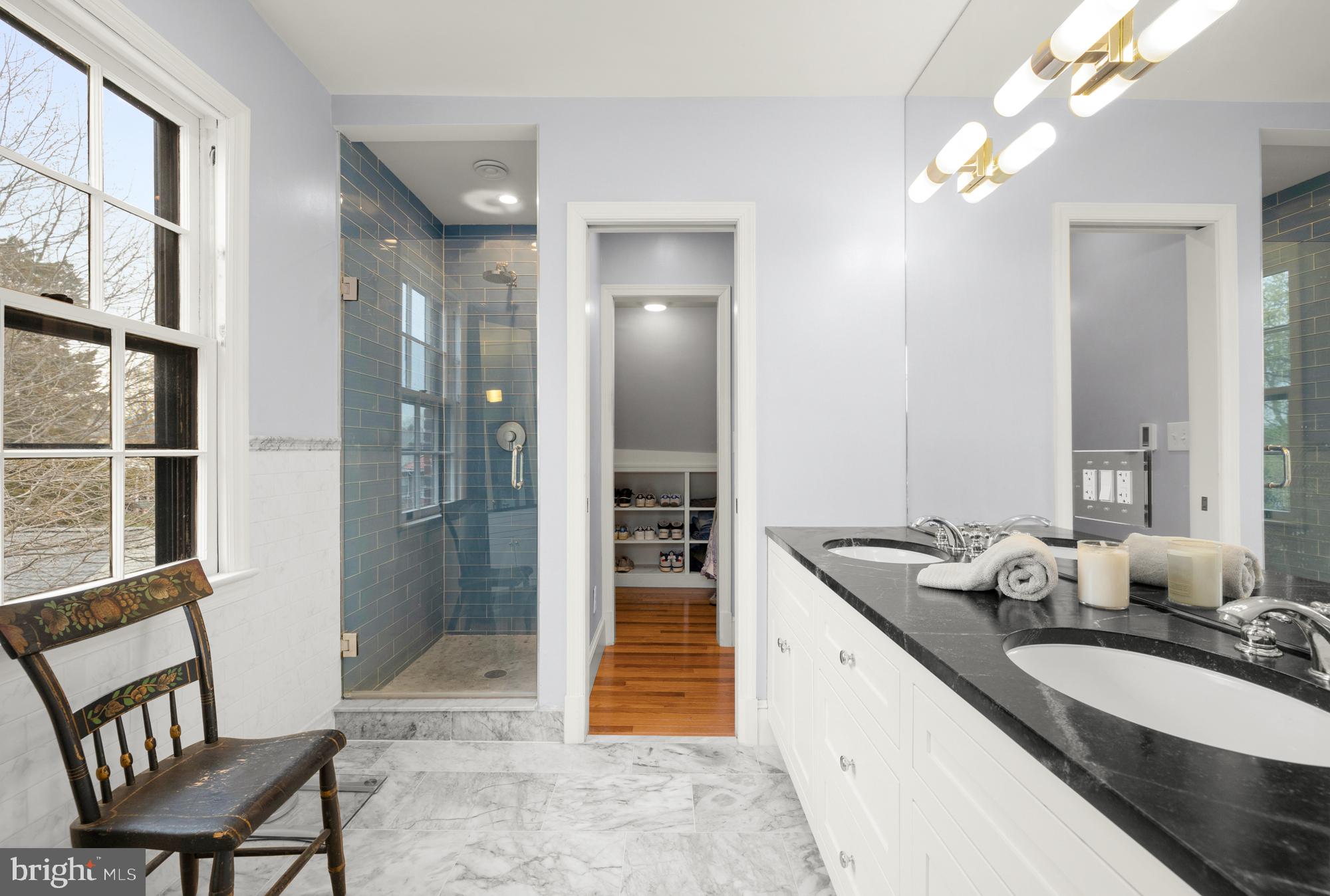 1441 Manchester Lane Northwest Washington, DC 20011 - Photo 36 of 63 a spacious bathroom with a granite countertop sink a mirror and shower