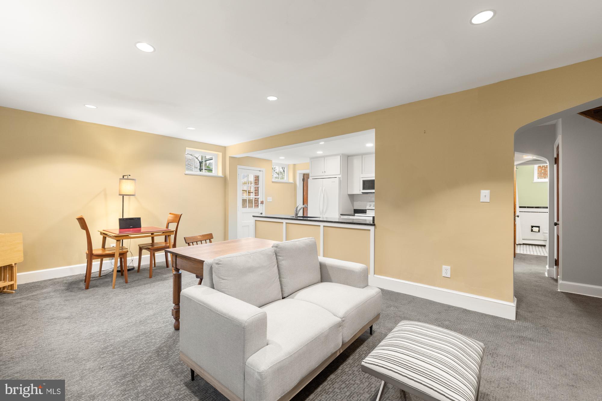1441 Manchester Lane Northwest Washington, DC 20011 - Photo 41 of 63 a living room with furniture and a dining table with kitchen view
