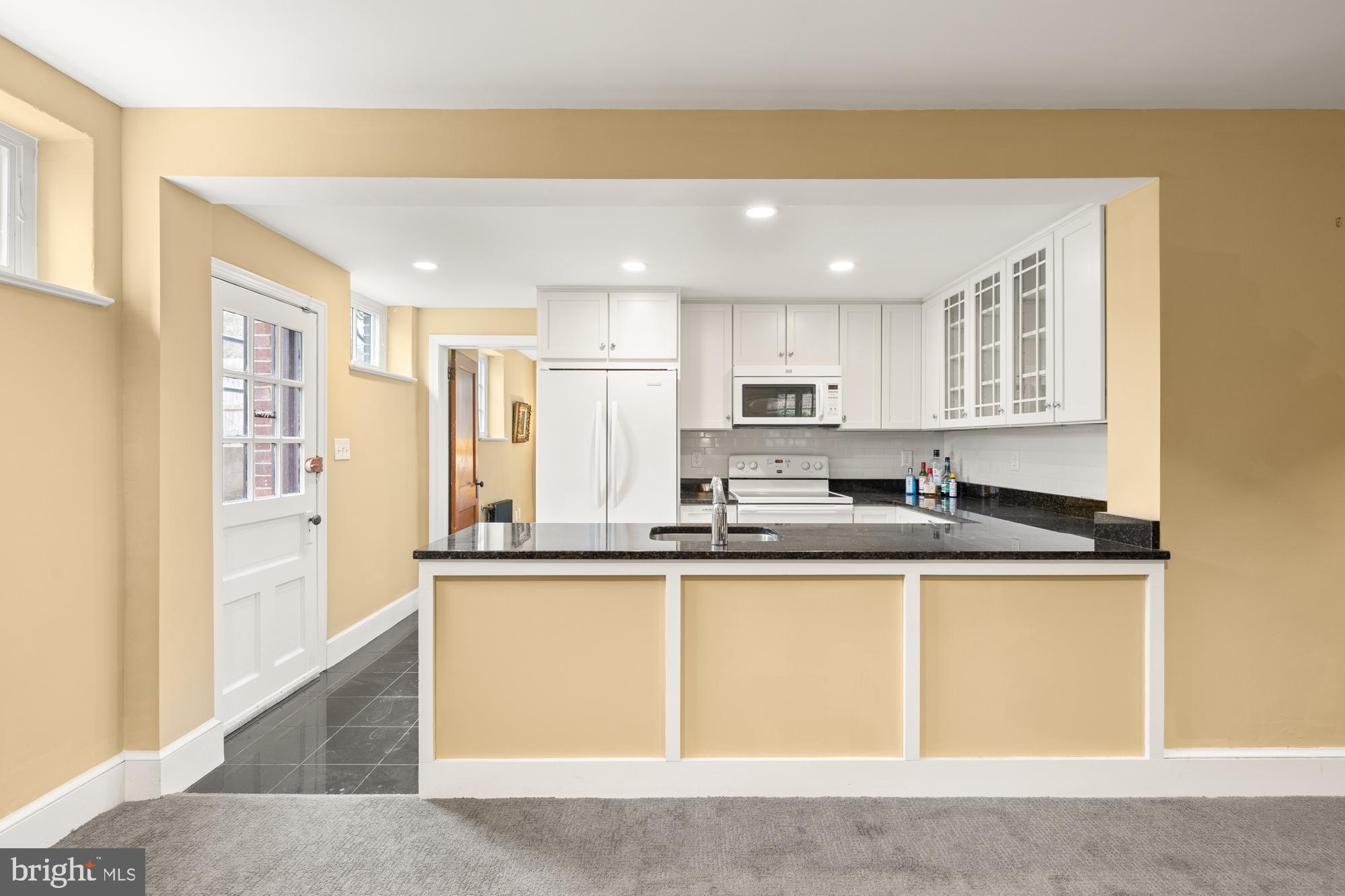 1441 Manchester Lane Northwest Washington, DC 20011 - Photo 43 of 63 a kitchen with stainless steel appliances granite countertop a sink and cabinets