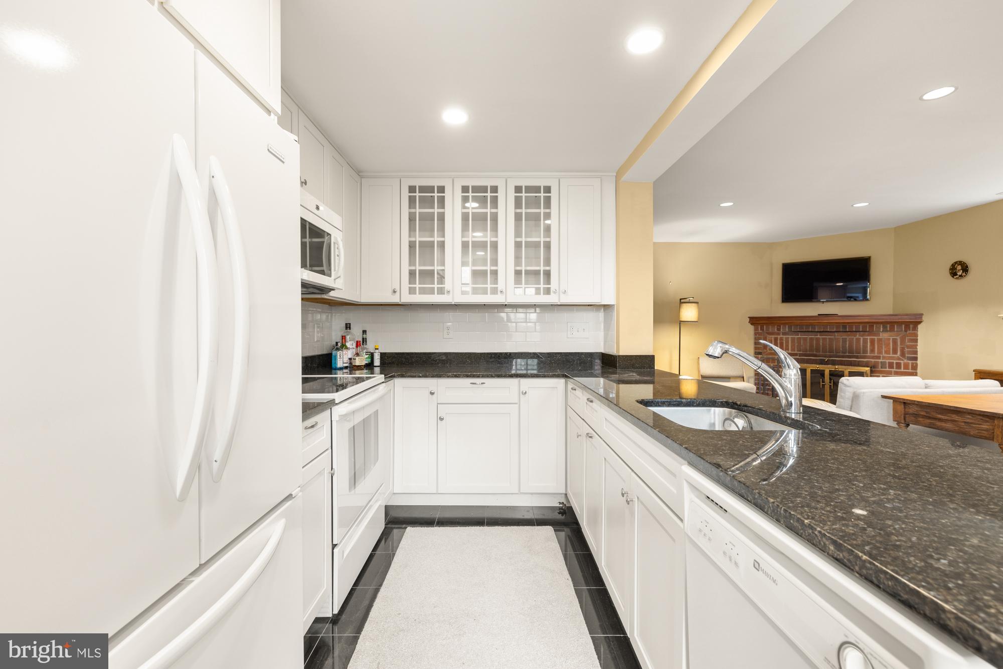 1441 Manchester Lane Northwest Washington, DC 20011 - Photo 44 of 63 a kitchen with a sink a stove a microwave and cabinets