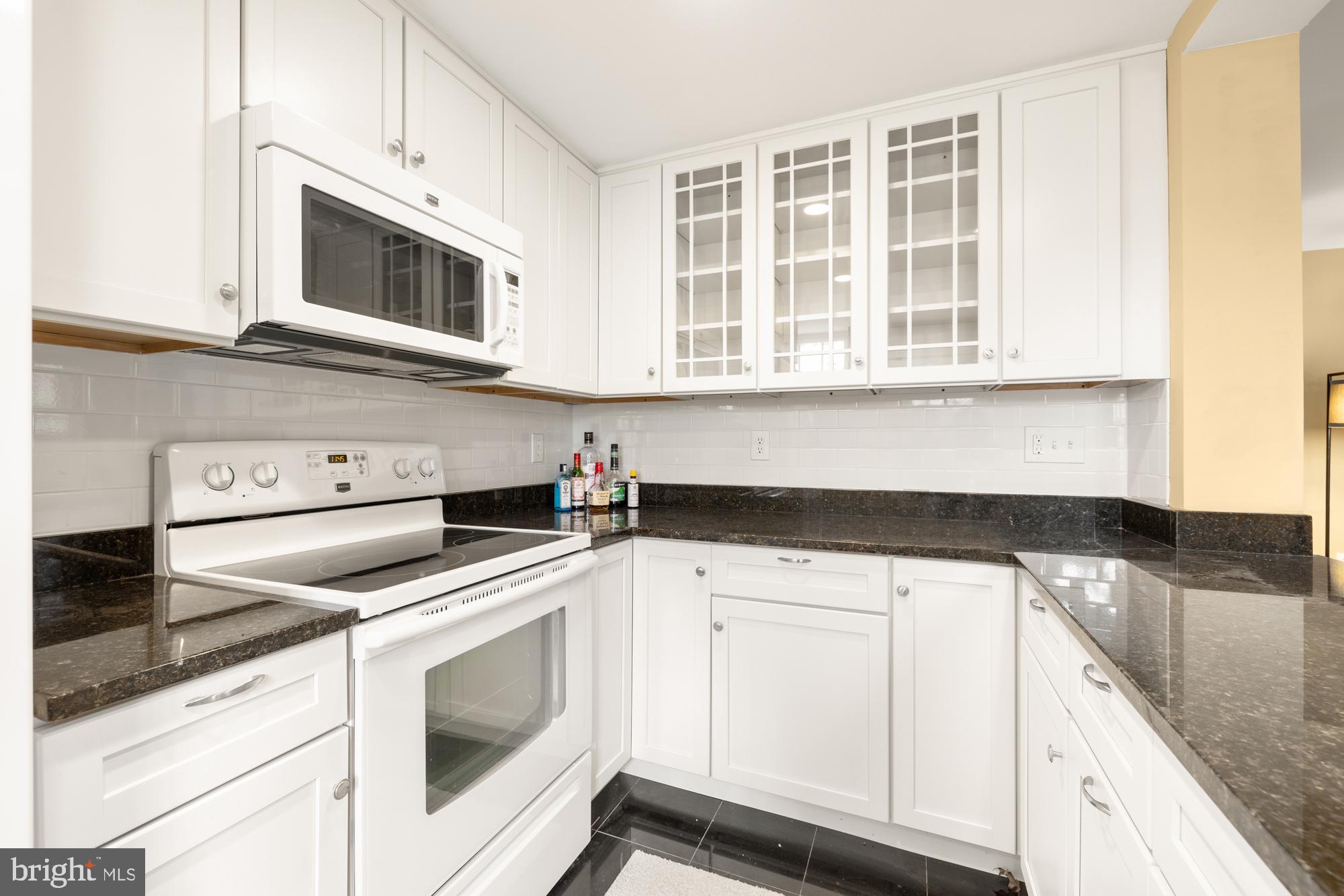 1441 Manchester Lane Northwest Washington, DC 20011 - Photo 45 of 63 a kitchen with stainless steel appliances granite countertop white cabinets and a sink
