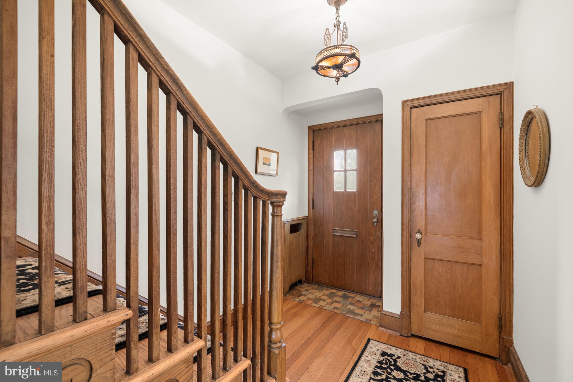 1441 Manchester Lane Northwest Washington, DC 20011 - Photo 5 of 63 a view of a hallway with wooden floor and stairs