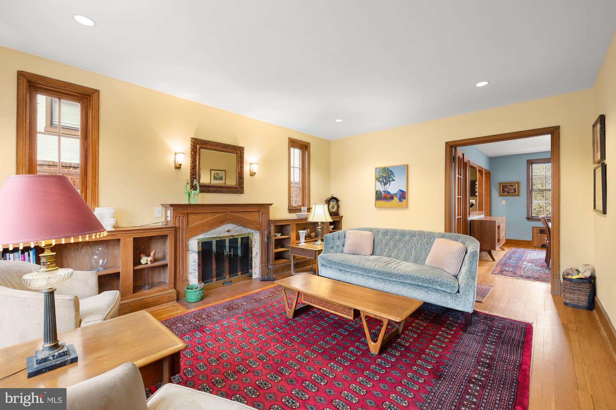 1441 Manchester Lane Northwest Washington, DC 20011 - Photo 7 of 63 a living room with furniture a fireplace and a large window