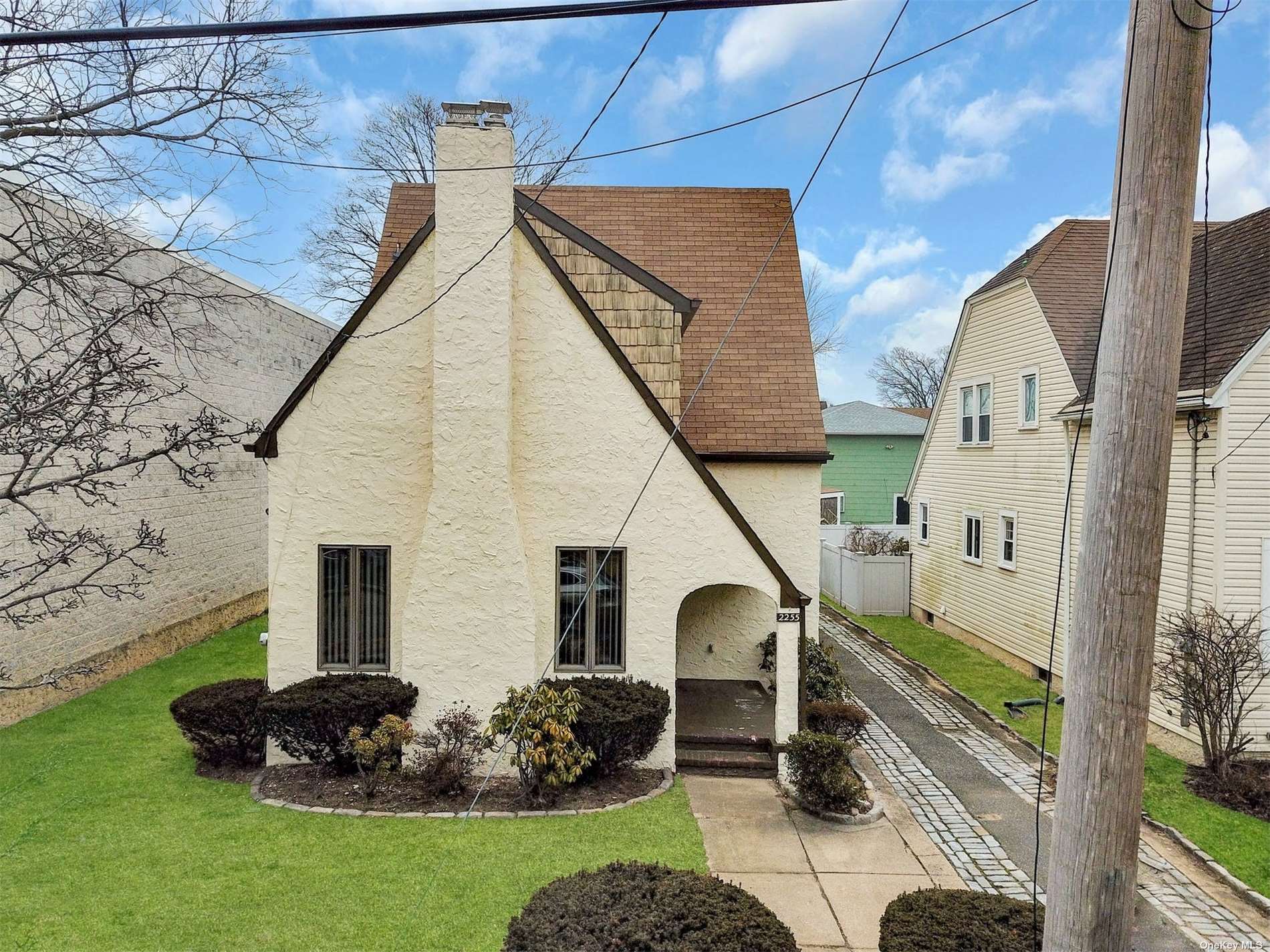a front view of a house with a garden