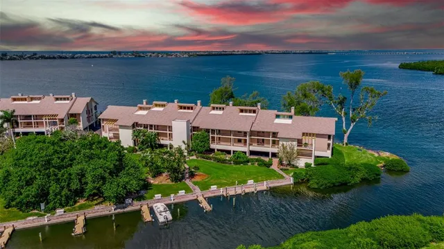 an aerial view of a house with a garden and lake view