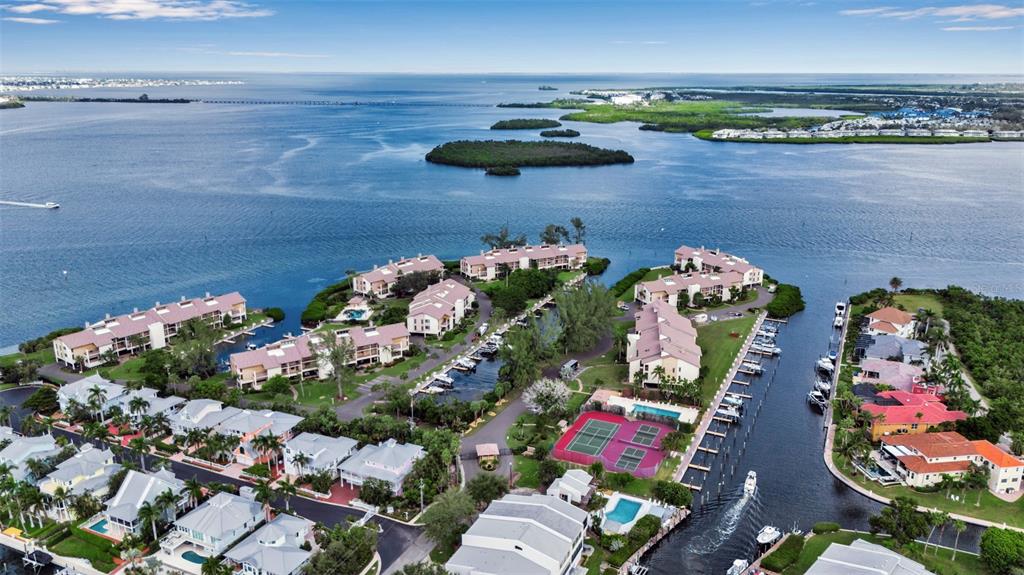 3840 Mariners Way, Unit 514A Cortez, FL 34215 - Photo 2 of 33 an aerial view of a house with a yard and lake view