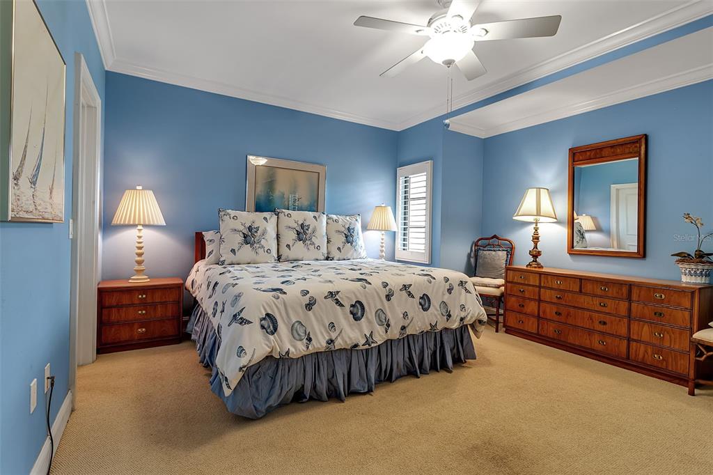 3840 Mariners Way, Unit 514A Cortez, FL 34215 - Photo 23 of 33 a spacious bedroom with a large bed and a chandelier