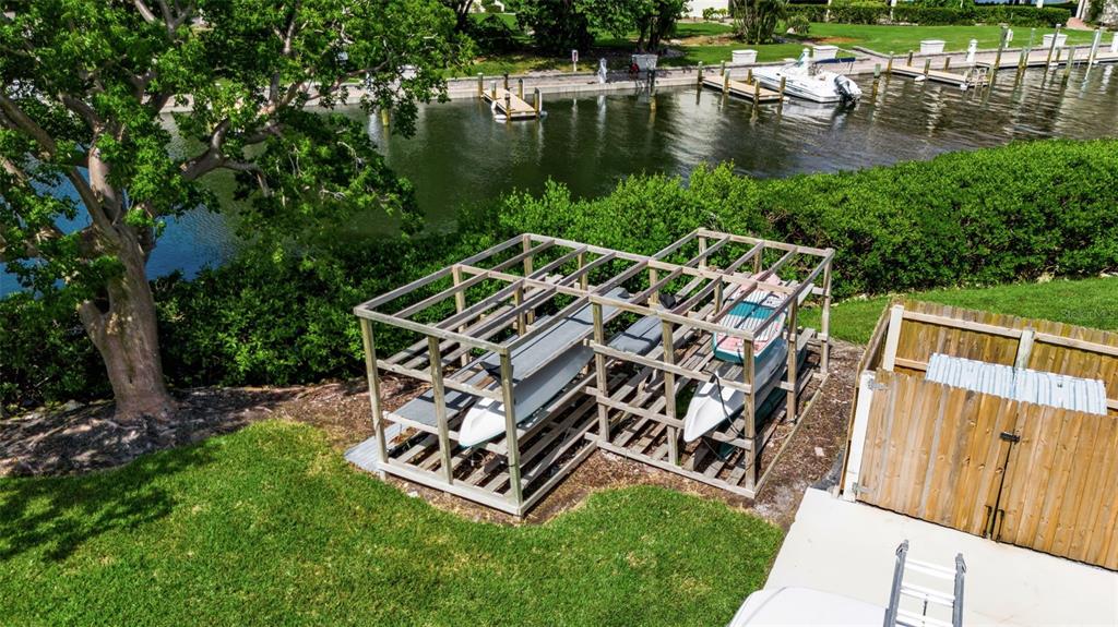 3840 Mariners Way, Unit 514A Cortez, FL 34215 - Photo 32 of 33 a view of a wooden deck with chairs and a yard