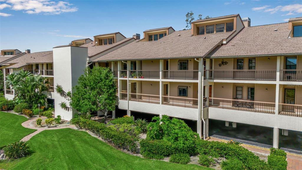 3840 Mariners Way, Unit 514A Cortez, FL 34215 - Photo 6 of 33 a front view of a house with a yard