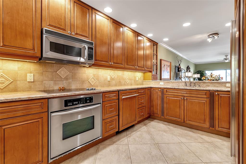 3840 Mariners Way, Unit 514A Cortez, FL 34215 - Photo 8 of 33 a kitchen with stainless steel appliances granite countertop a stove microwave and sink