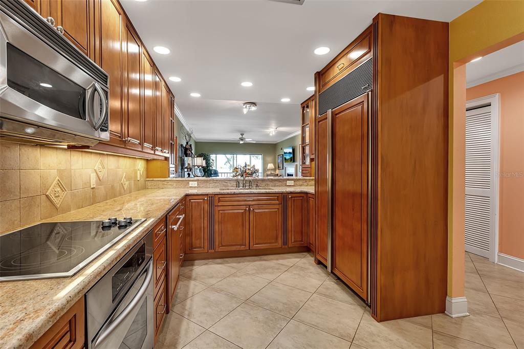 3840 Mariners Way, Unit 514A Cortez, FL 34215 - Photo 9 of 33 a kitchen with stainless steel appliances granite countertop a refrigerator and a sink