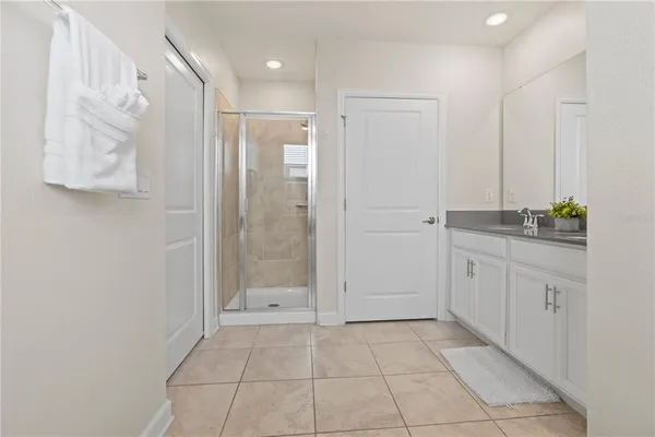 a bathroom with a shower and a sink