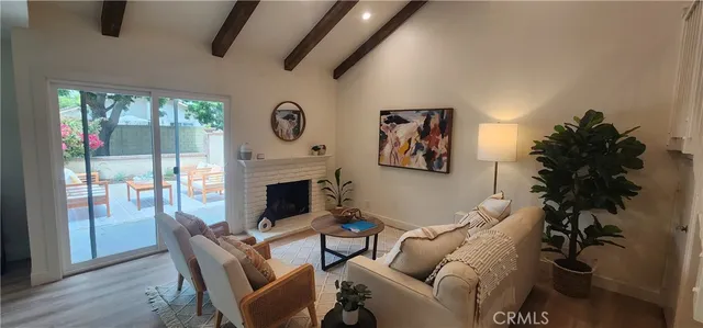 a living room with furniture a fireplace and a potted plant
