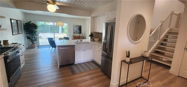 a view of kitchen with sink and wooden floor