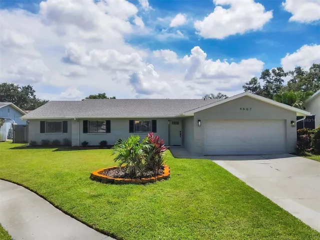 a front view of a house with a garden and yard