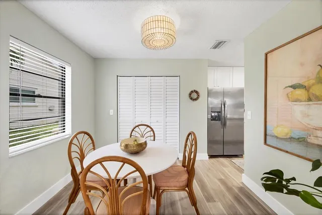 a dining room with furniture and wooden floor