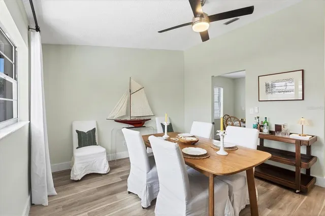 a view of a dining room with furniture and wooden floor